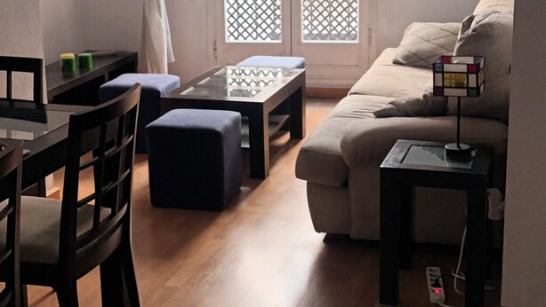Un soggiorno con divano, tavolino, mobile TV e zona pranzo con tavolo e sedie.