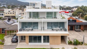 A modern building with a flat roof, large windows, and a balcony. - Dromana Beach Suites - 103 (Dromana)