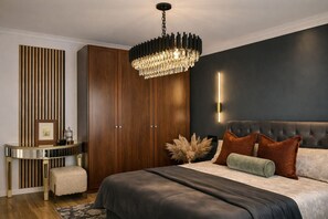 Ein Schlafzimmer mit einem großen Bett, einem Holzschrank, einem runden Nachttisch und einer modernen Deckenleuchte.