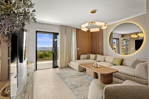 A modern living room with a sectional sofa, a coffee table, and a large mirror. - Olive Luxe Penthouse with Jacuzzi and Sea View (Zadar)