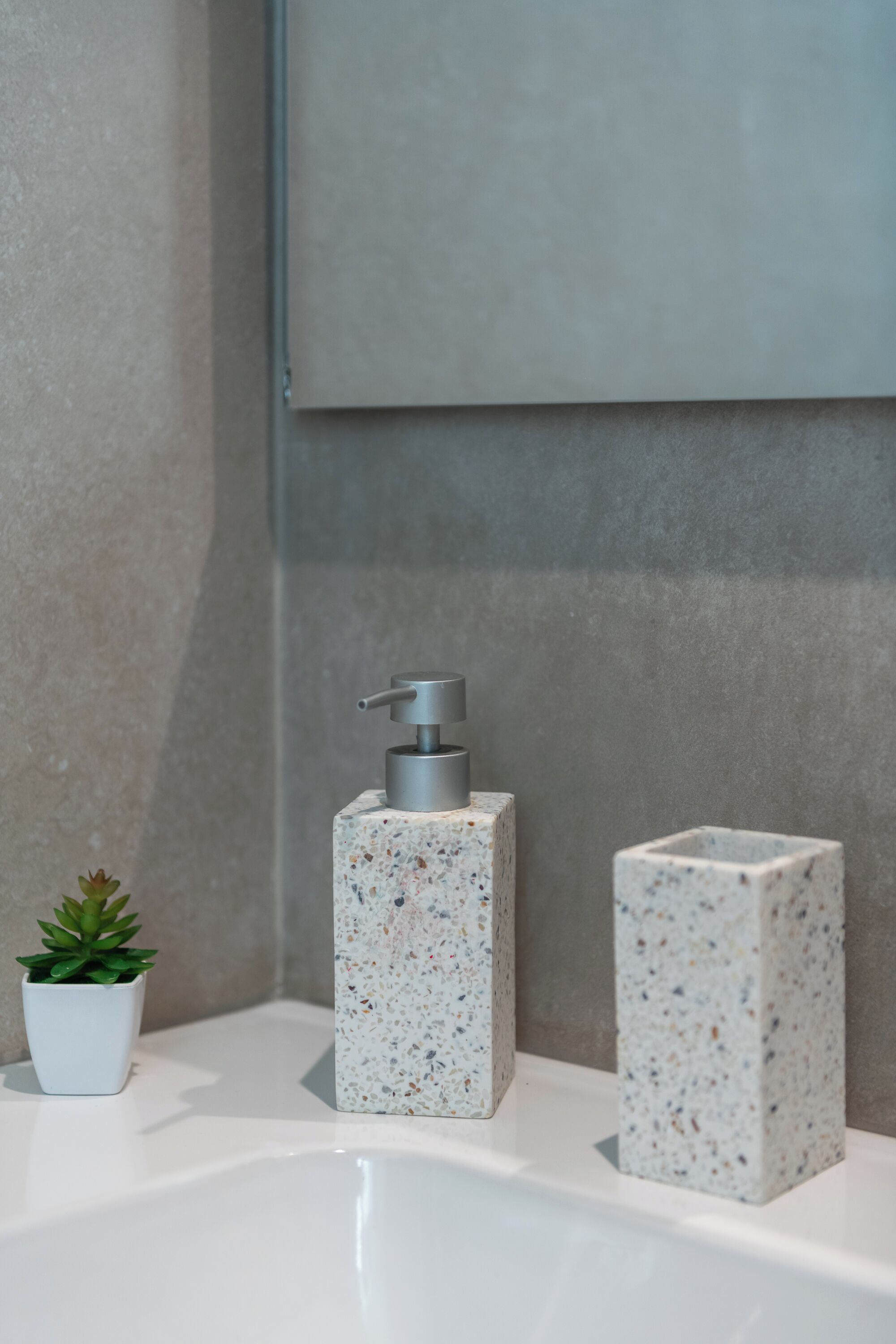 A bathroom sink with a soap dispenser and two soap bars.