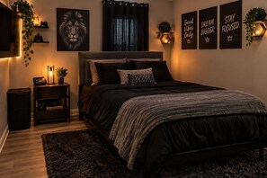 A bedroom with a bed, bedside tables, a wall-mounted TV, and motivational posters. -  Your Home Away From Home – Spacious, Comfortable & Charming  (Fort Worth)