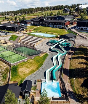 A water park with multiple slides and a swimming pool.
