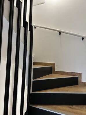 A staircase with wooden steps and a metal handrail. - Ljubica House (Vodice)