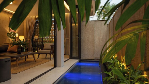 A modern interior with a seating area, a small water feature, and indoor plants. - Holiday 3-Bedroom Delightful Villa @ Phan Thiet (Phan Thiết)