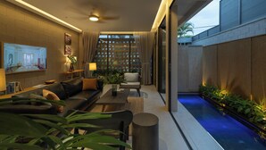 A modern living room with a sofa, coffee table, and a TV mounted on the wall. - Holiday 3-Bedroom Delightful Villa @ Phan Thiet (Phan Thiết)