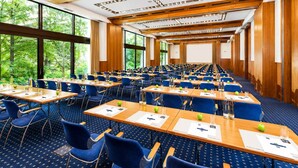 A conference room with rows of tables, chairs, and a large screen. - 2 Person Holiday Park Home in Sulzbach (Sulzbach)
