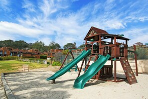 A playground with two slides and a climbing structure. - Del Mar Daze - Pet Friendly with AC in Del Mar with Ocean Views (Del Mar)