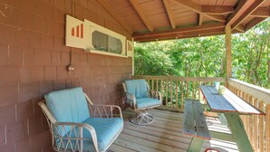 A covered outdoor seating area with two chairs and a table. - 3 Mi to Hiking & Beaches: Rustic Maine Cabin (Stockton Springs)