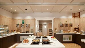 A modern kitchen with wooden cabinets, a central island with breakfast items, and built-in appliances. - 1 Person Holiday Park Home in Herrenberg (Herrenberg)