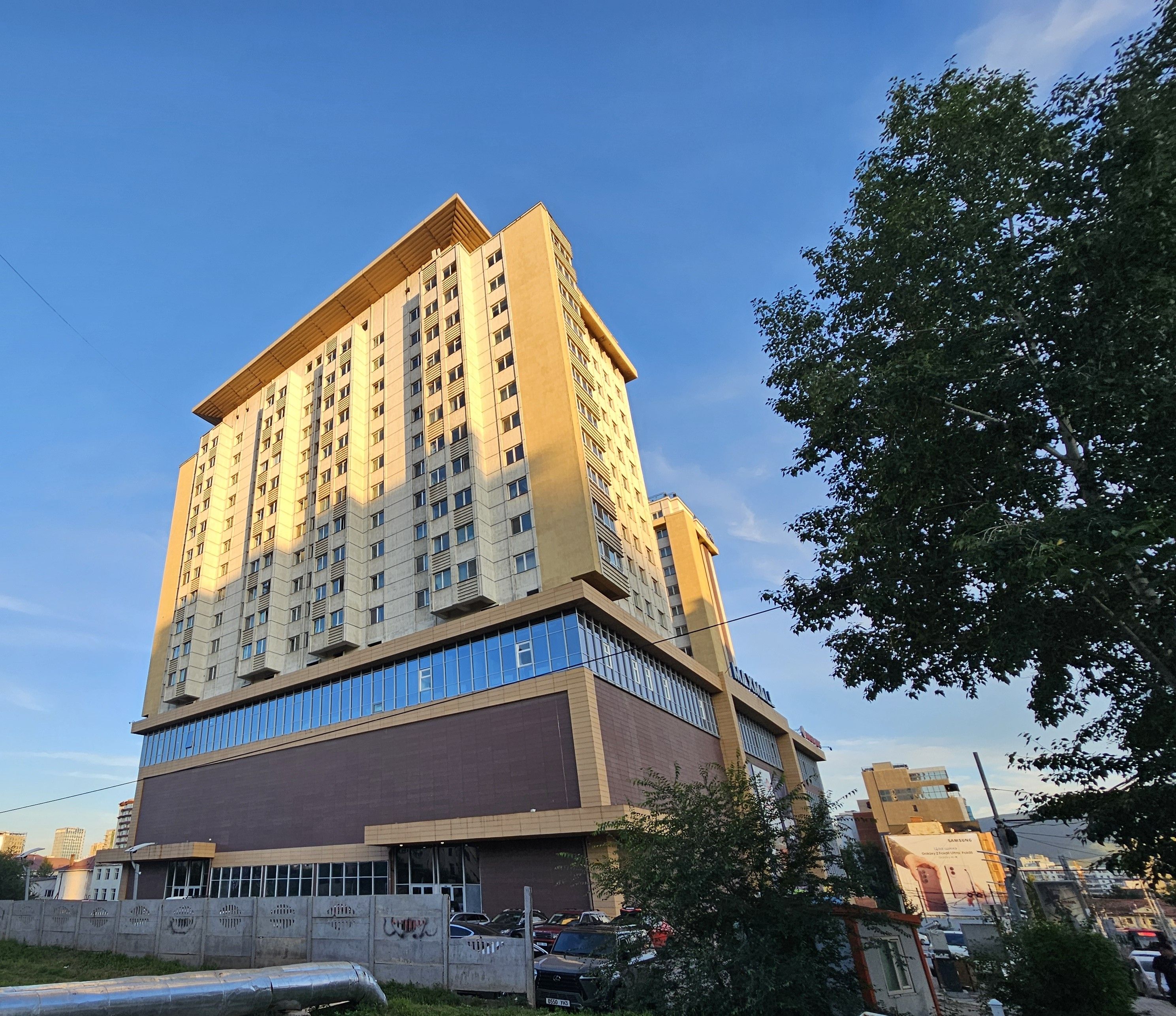 A multi-story building with a flat roof and a large sign on the side.