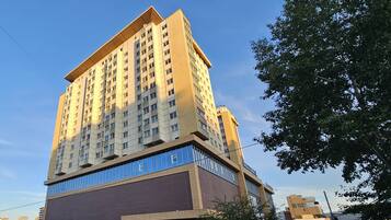 A multi-story building with a flat roof and a large sign on the side.