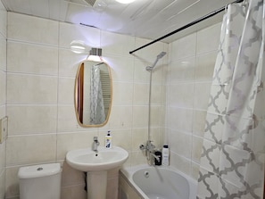 A bathroom with a pedestal sink, a toilet, a bathtub, and a shower. - Max Central City Apartment (Ulaanbaatar)