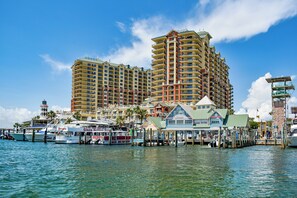 A waterfront hotel with multiple high-rise buildings, a marina with boats, and a pier with a small building labeled "Waterwalk Marina". - Beach Condo~Steps from Beach~Sleeps 4~Pool~Hot Tub~ (Miramar Beach)