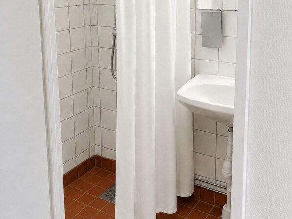 A bathroom with a shower, a sink, and a tiled floor. - 5 Star Holiday Home in Uddevalla (Uddevalla)