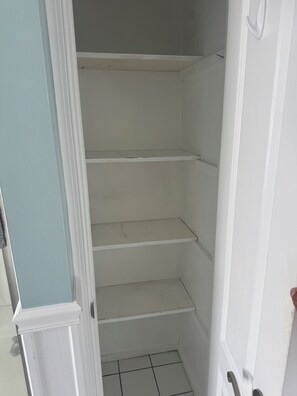 A closed door with a white frame and a light blue wall.