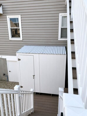 A covered outdoor area with a white metal roof, a white door, and a white railing. - Waterfront Lagoon Escape , Sunset Views, Private Dock and Minutes to LBI (Stafford Township)