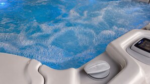 A hot tub with a control panel and a wooden ceiling structure. - Waterfront Lagoon Escape , Sunset Views, Private Dock and Minutes to LBI (Stafford Township)
