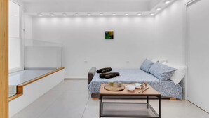 A modern bedroom with a bed, bedside table, and a small artwork on the wall. - MA6 [Cathedral] • Spacious luxury apartment in a central location • (Milano)