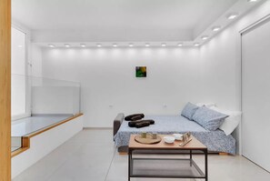 A modern bedroom with a bed, bedside table, and a small artwork on the wall. - MA6 [Cathedral] • Spacious luxury apartment in a central location • (Milano)