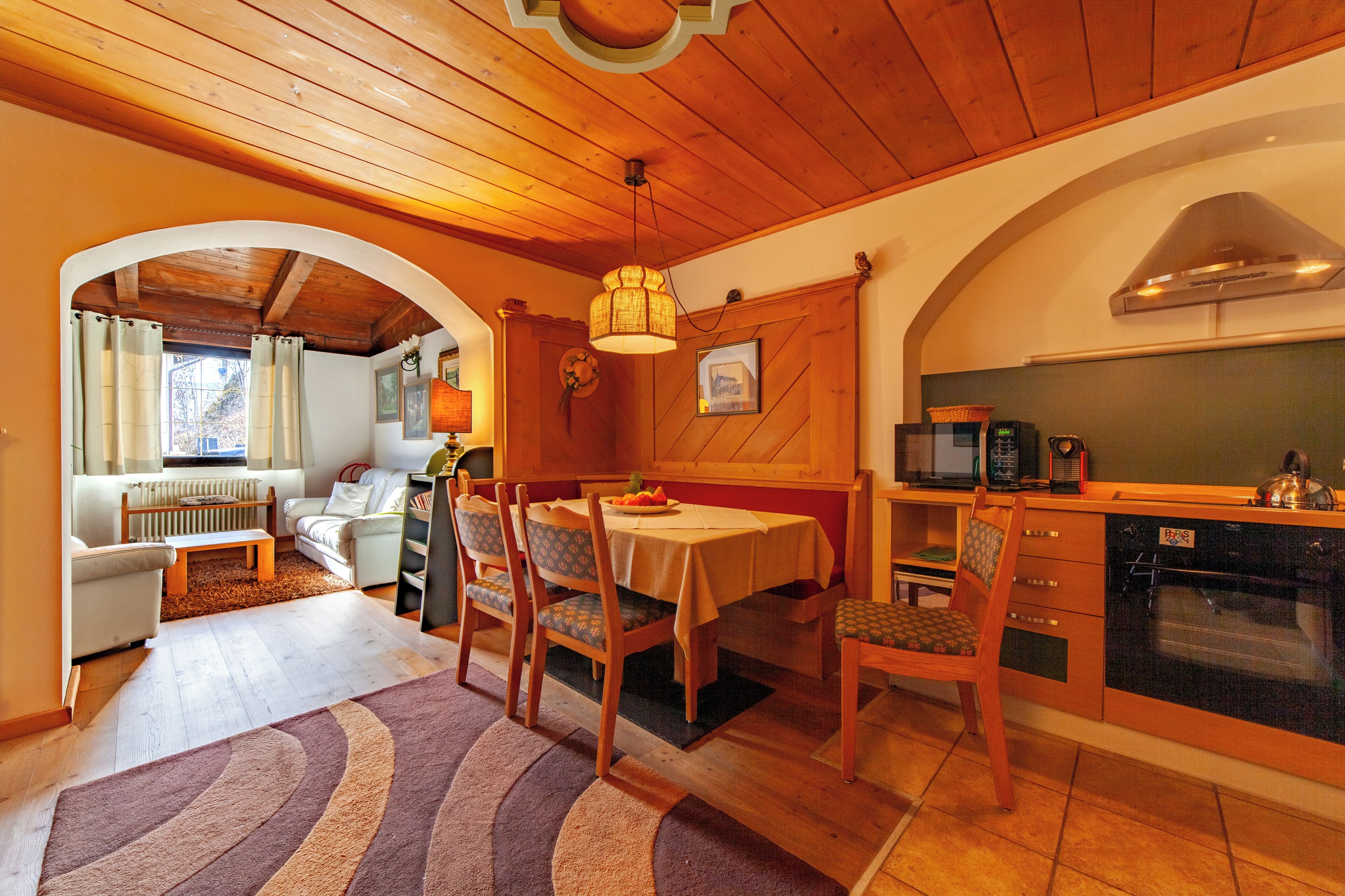 A cozy interior with a dining area, kitchen, and living space.