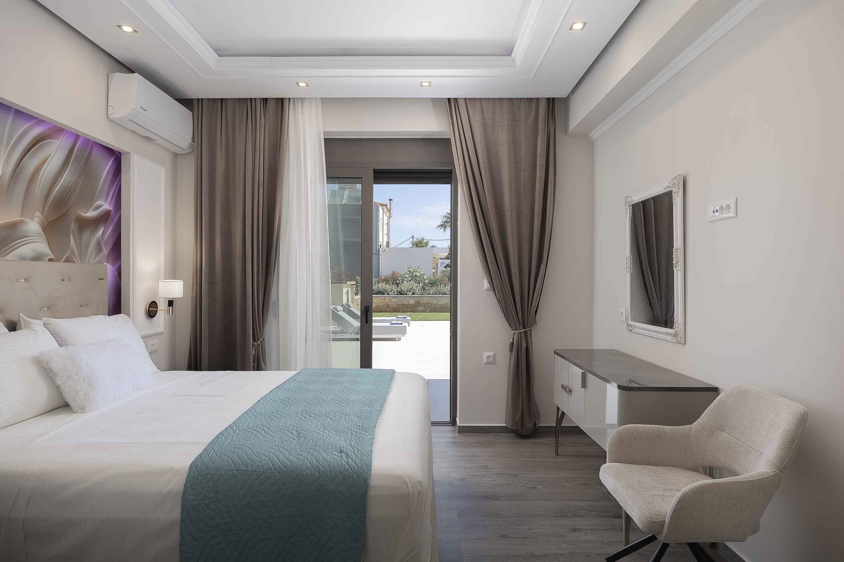 A hotel room with a bed, a desk, a chair, and a view of the outdoors.