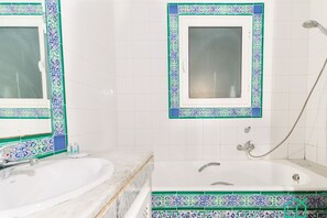 A bathroom with a white sink, a bathtub, and a shower. - Rd Zephyr Marsa Corniche 2 bedrooms (La Marsa)