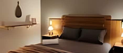 A bedroom with a bed, bedside tables, an air conditioning unit, and a hanging light fixture.