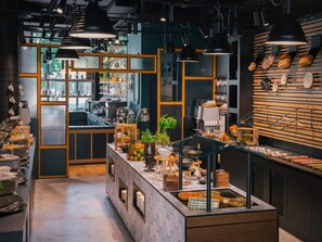 A modern cafe interior with a counter, seating area, and a display of pastries. - 1 Person Holiday Park Home in Leipzig (Leipzig)