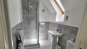 A modern bathroom with a glass-enclosed shower, a sink, and a toilet. - Large Private Ensuite Room + Parking,
near Gatwick (Horley)