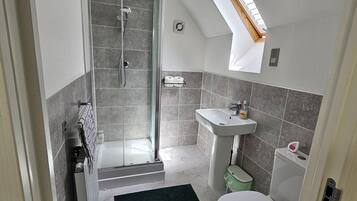 Shower, hair dryer, soap, toilet paper