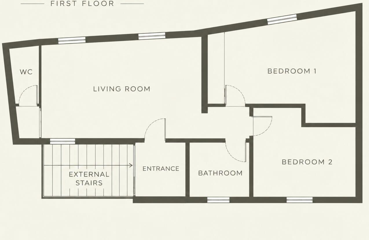 A first-floor floor plan with a living room, two bedrooms, a bathroom, an external staircase, and a WC.