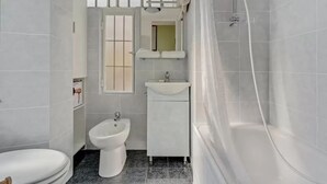 A bathroom with a toilet, bidet, sink, and shower. - MOD1 - BEAUTIFUL APARTMENT WITH A TERRACE (Milano)