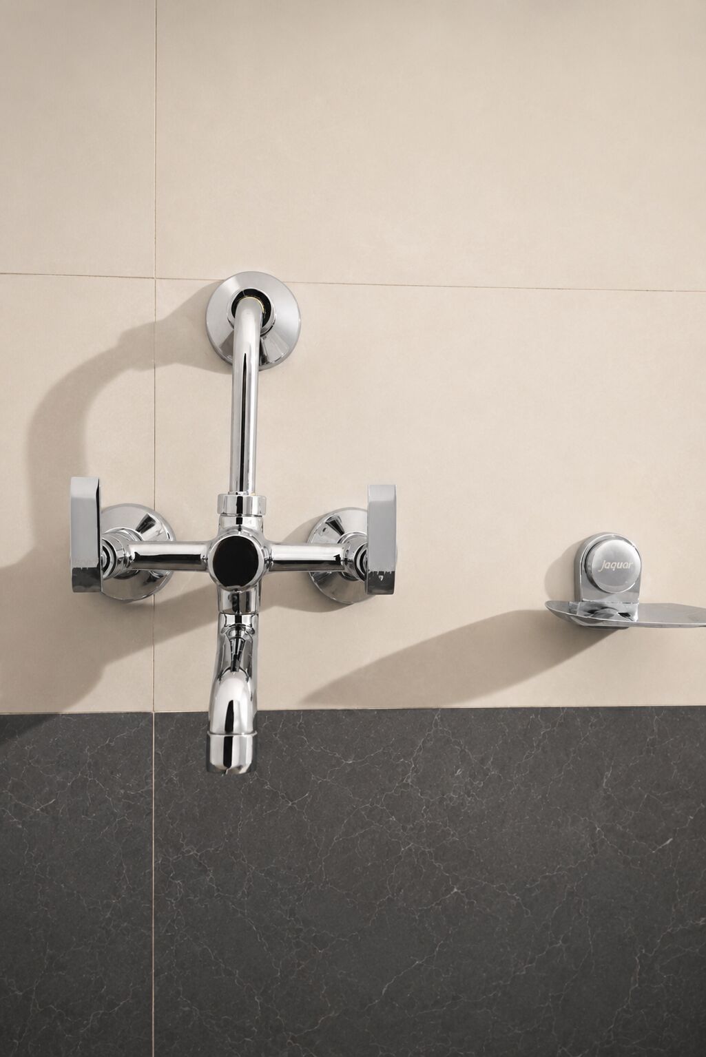 A modern bathroom with a wall-mounted shower, a handheld showerhead, and a separate handheld showerhead on a shelf.