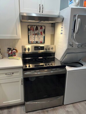 A kitchen with a stainless steel stove, oven, and microwave. There is a 'Welcome to the Beach' sign above the stove. - N. Wildwood Cottage 2 1/2 blocks to beach (North Wildwood)