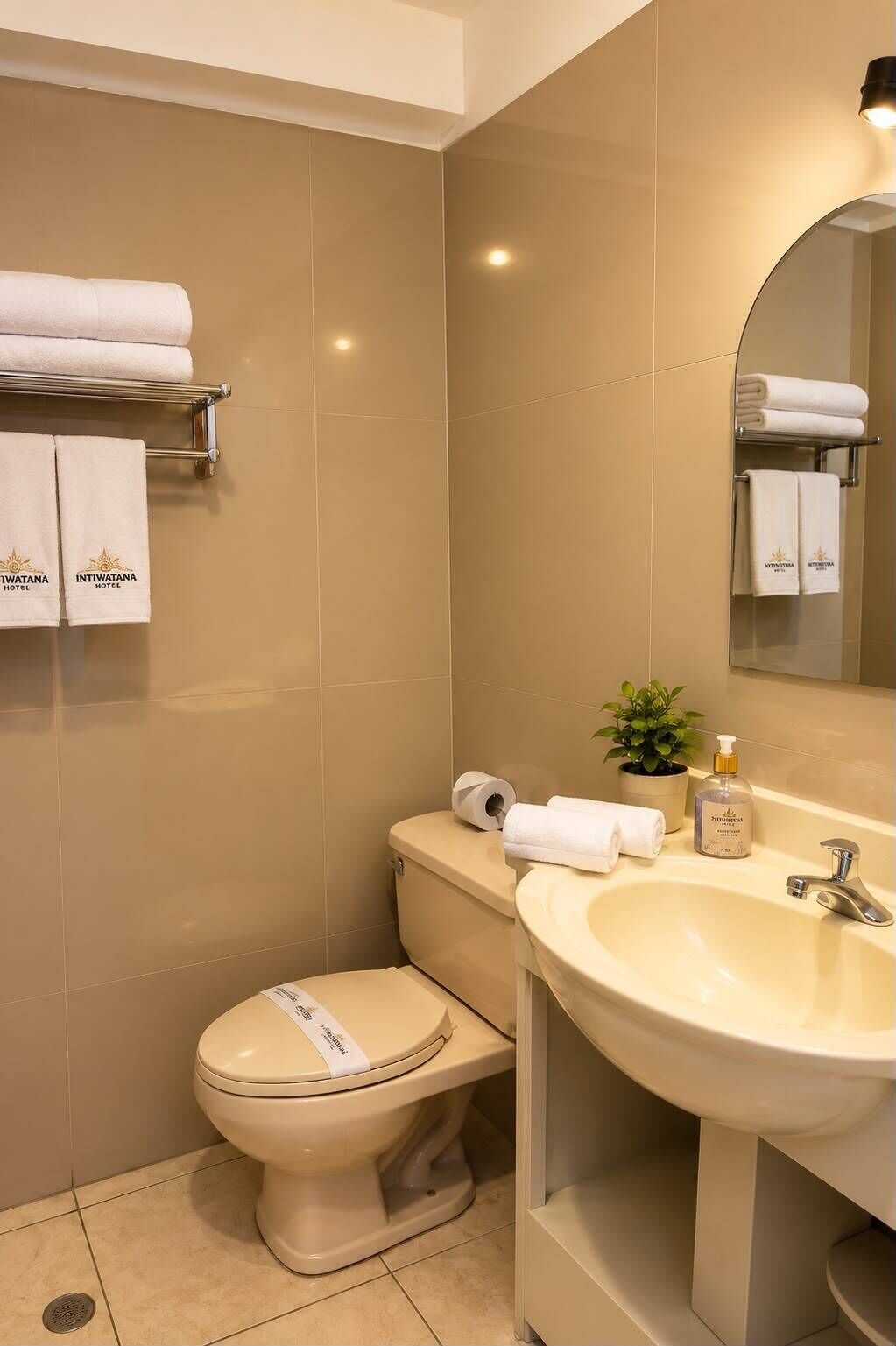 A bathroom with a toilet, sink, and towel rack.