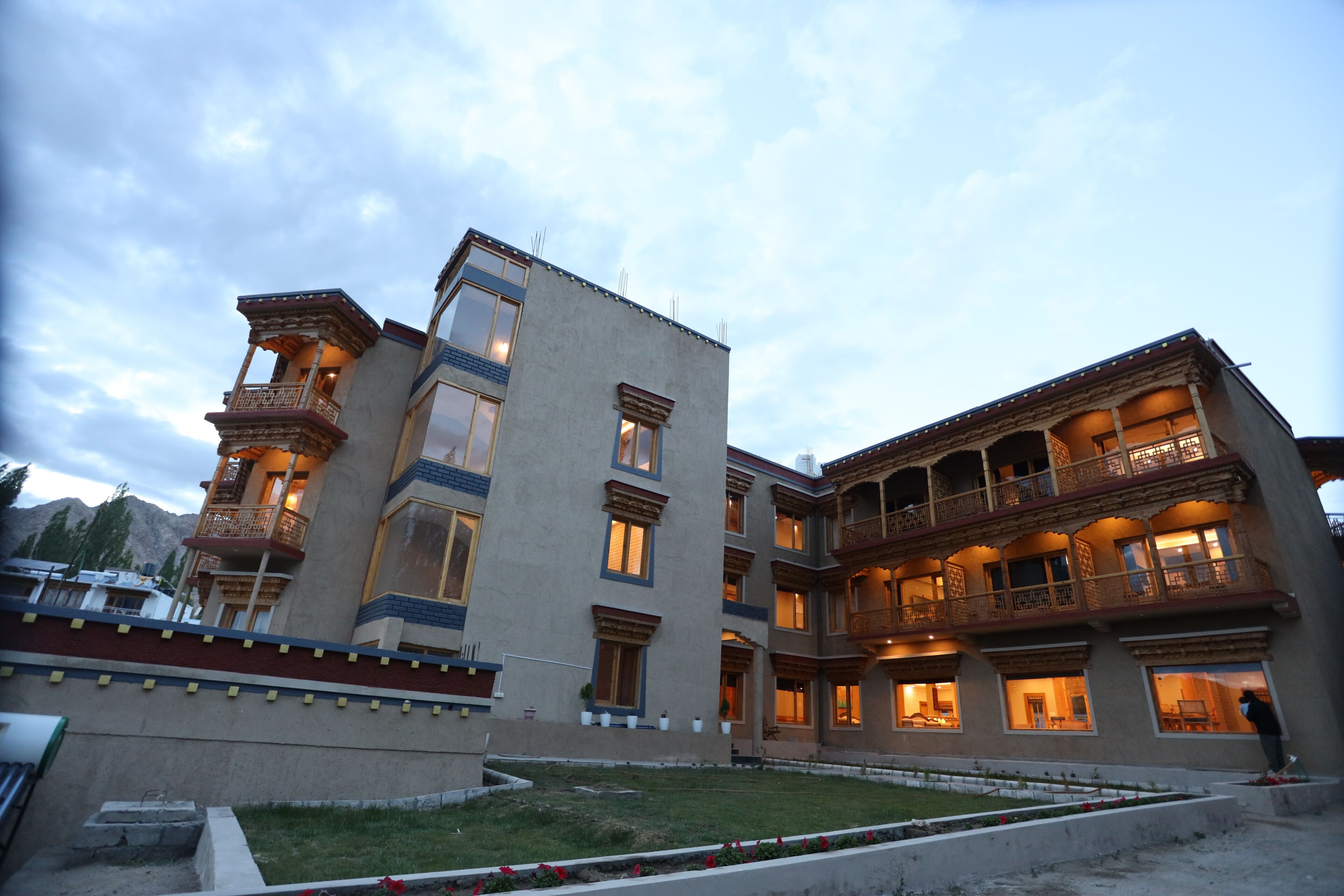 A multi-story building with traditional architectural elements, including balconies and decorative railings.