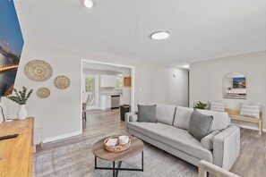 A modern living room with a sofa, coffee table, and decorative wall art.