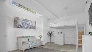 A modern room with a bunk bed, a sofa, a painting, and a small desk. - ZU12/4 Spacious and bright apartment in Milan (Milano)