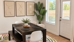A dining area with a dark wooden table, white chairs, and a red and white patterned rug.