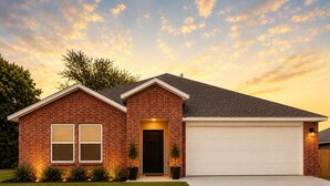 A two-story brick house with a garage, a front door, and a well-maintained lawn.