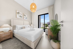 A modern bedroom with a large bed, bedside lamps, a view of the city, and a potted plant. - Free Housekeeping Visits During Your Stay - Stayshort - Exceptional 3 Bedroom Villa in Emaar South That Sleeps 8 (Dubai)