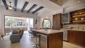 A modern kitchen with a central island, wooden cabinets, and a built-in oven. - Awesome 2-bedroom condo with AC in vibrant Puerto Vallarta in Zona Romántica (Puerto Vallarta)