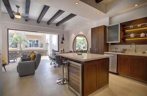 A modern kitchen with a central island, wooden cabinets, and a built-in oven. - Awesome 2-bedroom condo with AC in vibrant Puerto Vallarta in Zona Romántica (Puerto Vallarta)