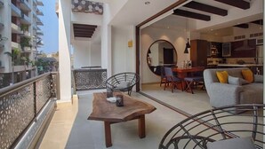 A modern apartment with a balcony, a dining area, and a kitchen. - Awesome 2-bedroom condo with AC in vibrant Puerto Vallarta in Zona Romántica (Puerto Vallarta)