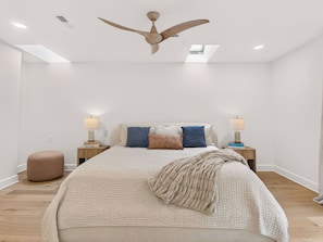 A bedroom with a bed, two bedside tables, a ceiling fan, and a window. - Luxury Blue Ridge Retreat - Hot Tub - 15 Min to Early Mountain Vineyard (Stanardsville)