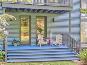 A porch with two chairs and a small table, a potted plant, and a staircase leading to the entrance. - Luxury Blue Ridge Retreat - Hot Tub - 15 Min to Early Mountain Vineyard (Stanardsville)