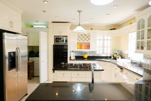 A modern kitchen with a central island, stainless steel appliances, and a pendant light. - Apartment in Cap Estate, Gros Islet (Gros Islet)