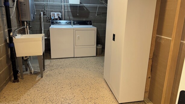 A laundry room with a sink, two washing machines, and a metal trash can. - Private Pool Retreat, Fire Pit, Game Room (Oak Grove)