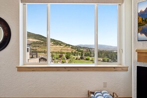 A room with a large window, a wooden shelf, and a framed picture on the wall. - New Listing Canyons Resort, Silverado, Pool, Golf! (Park City)